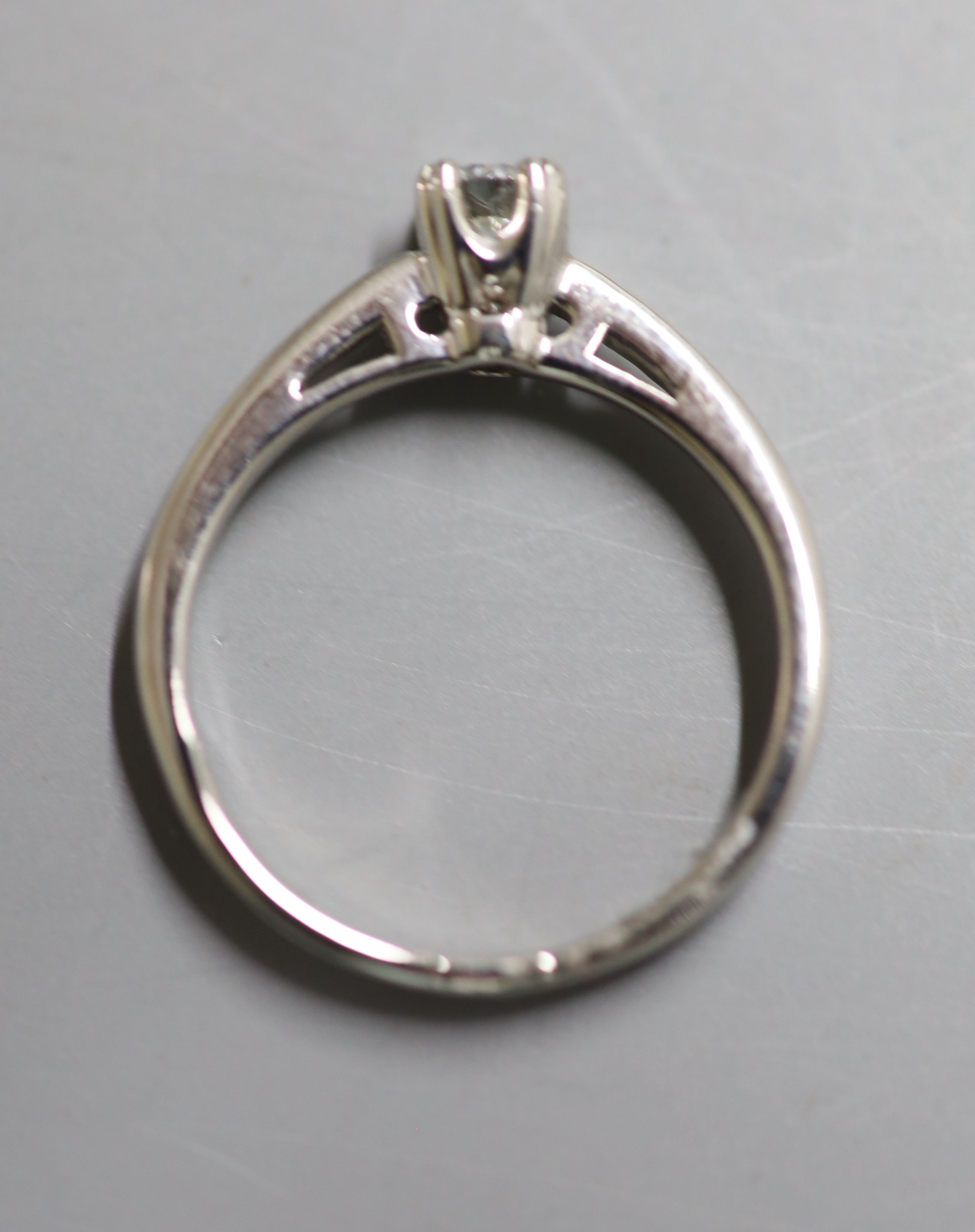 A modern white metal (stamped Plat) and solitaire diamond ring, size N, gross 4 grams,